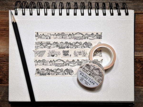 Washi tape with detailed drawings of houses and farms and more in a fantasy map style.