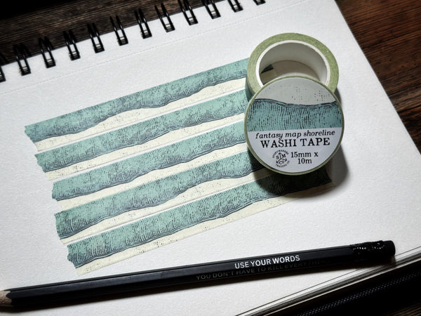 Washi tape with hand-drawn shoreline and water in a fantasy map style.